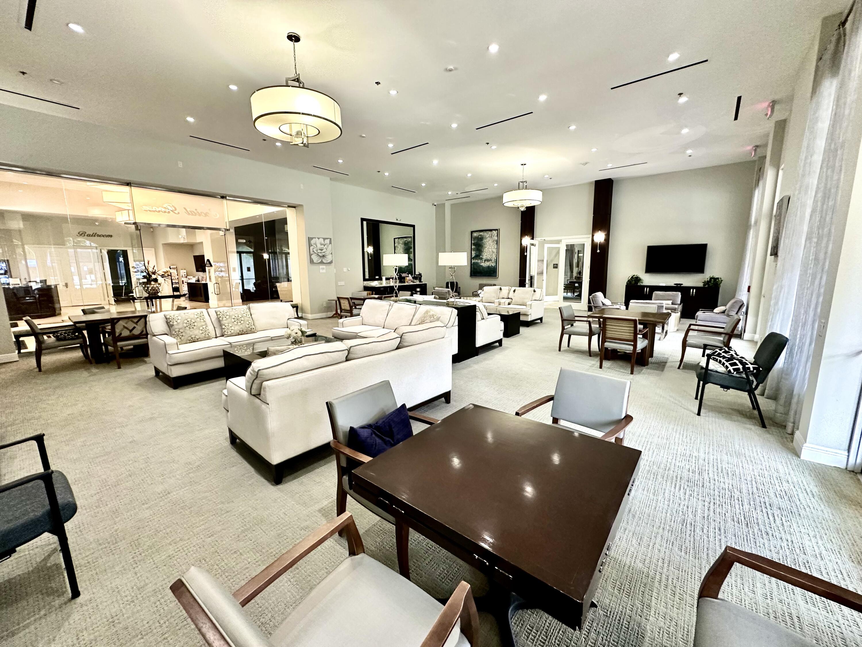 7096 Cataluna Circle Delray Beach, FL 33446 - Photo 26 of 32 a living room with furniture kitchen view and a large window