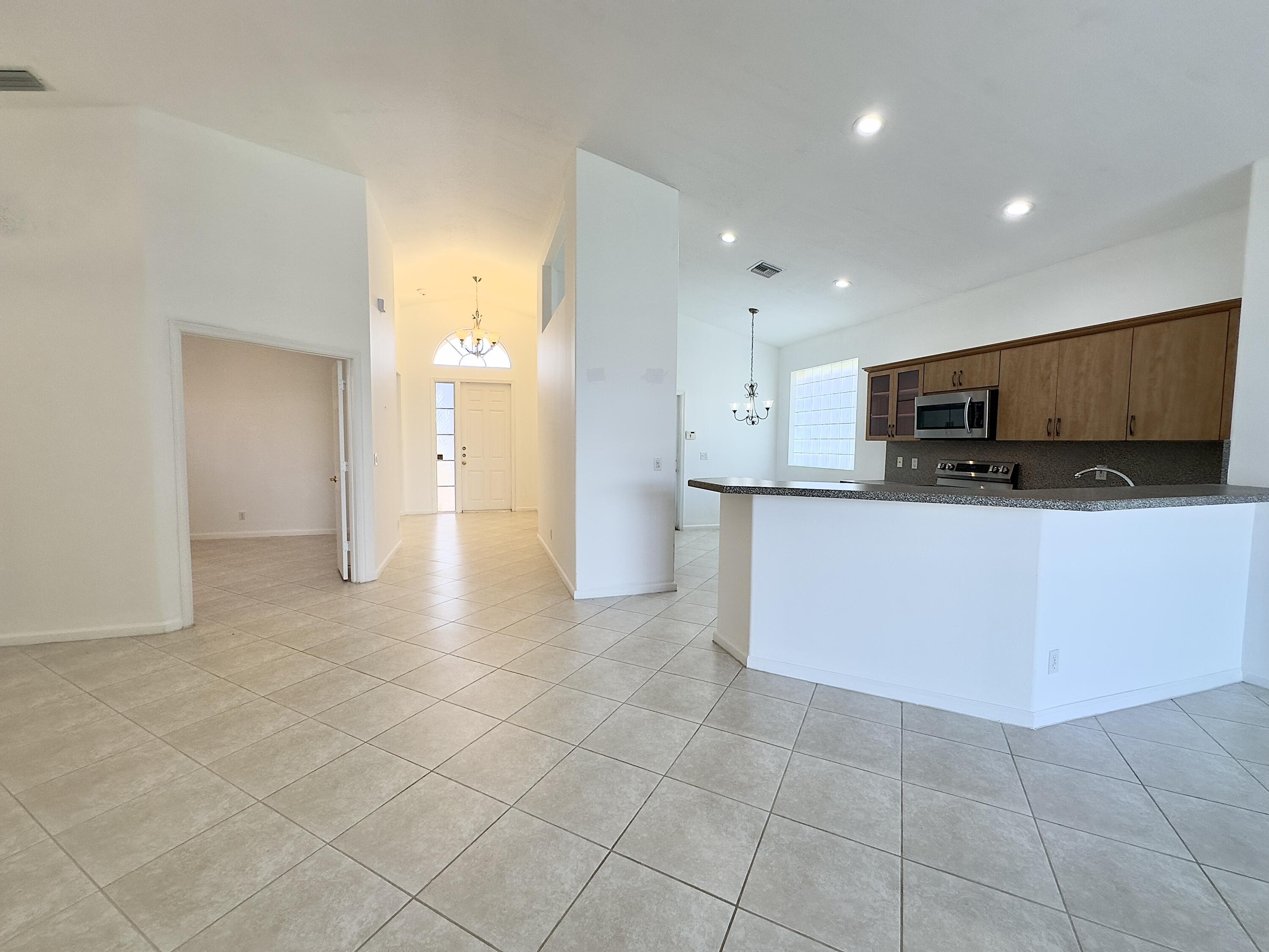 7096 Cataluna Circle Delray Beach, FL 33446 - Photo 31 of 32 a view of a kitchen with an empty space and a sink