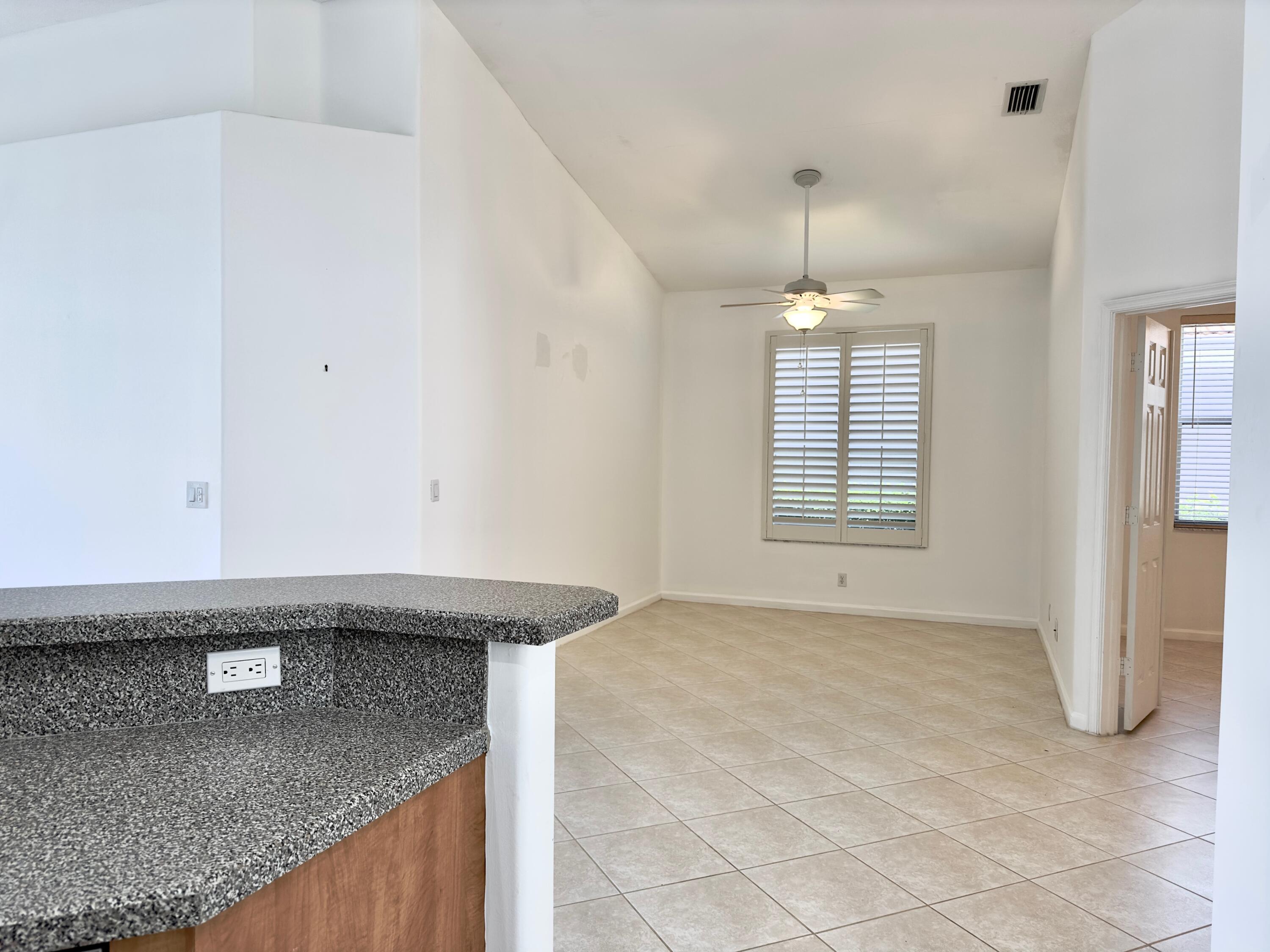 7096 Cataluna Circle Delray Beach, FL 33446 - Photo 8 of 32 a view of kitchen with granite countertop window