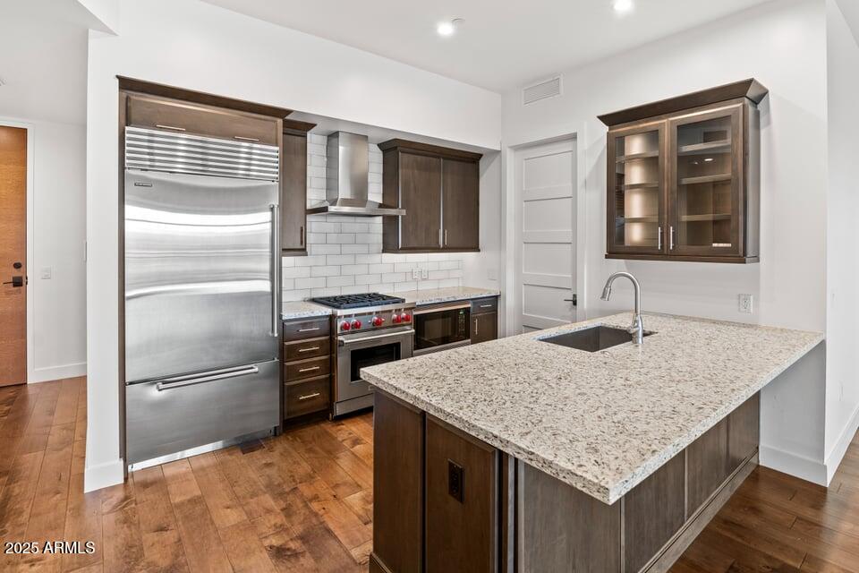 6166 North Scottsdale Road, Unit B2008 Paradise Valley, AZ 85253 - Photo 14 of 69 a kitchen with granite countertop a refrigerator and wooden cabinets