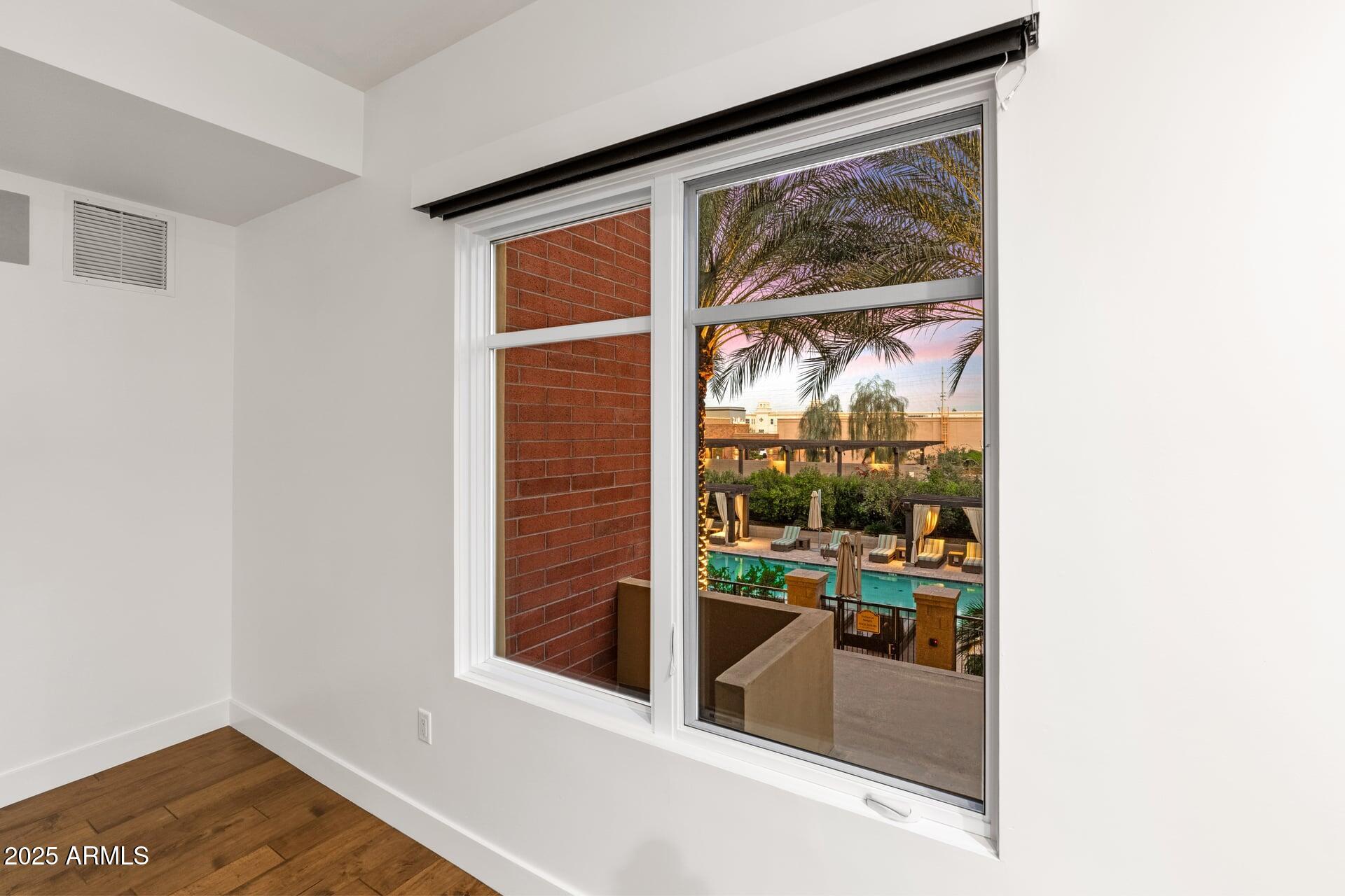 6166 North Scottsdale Road, Unit B2008 Paradise Valley, AZ 85253 - Photo 32 of 69 a view of a hallway with wooden floor and a window