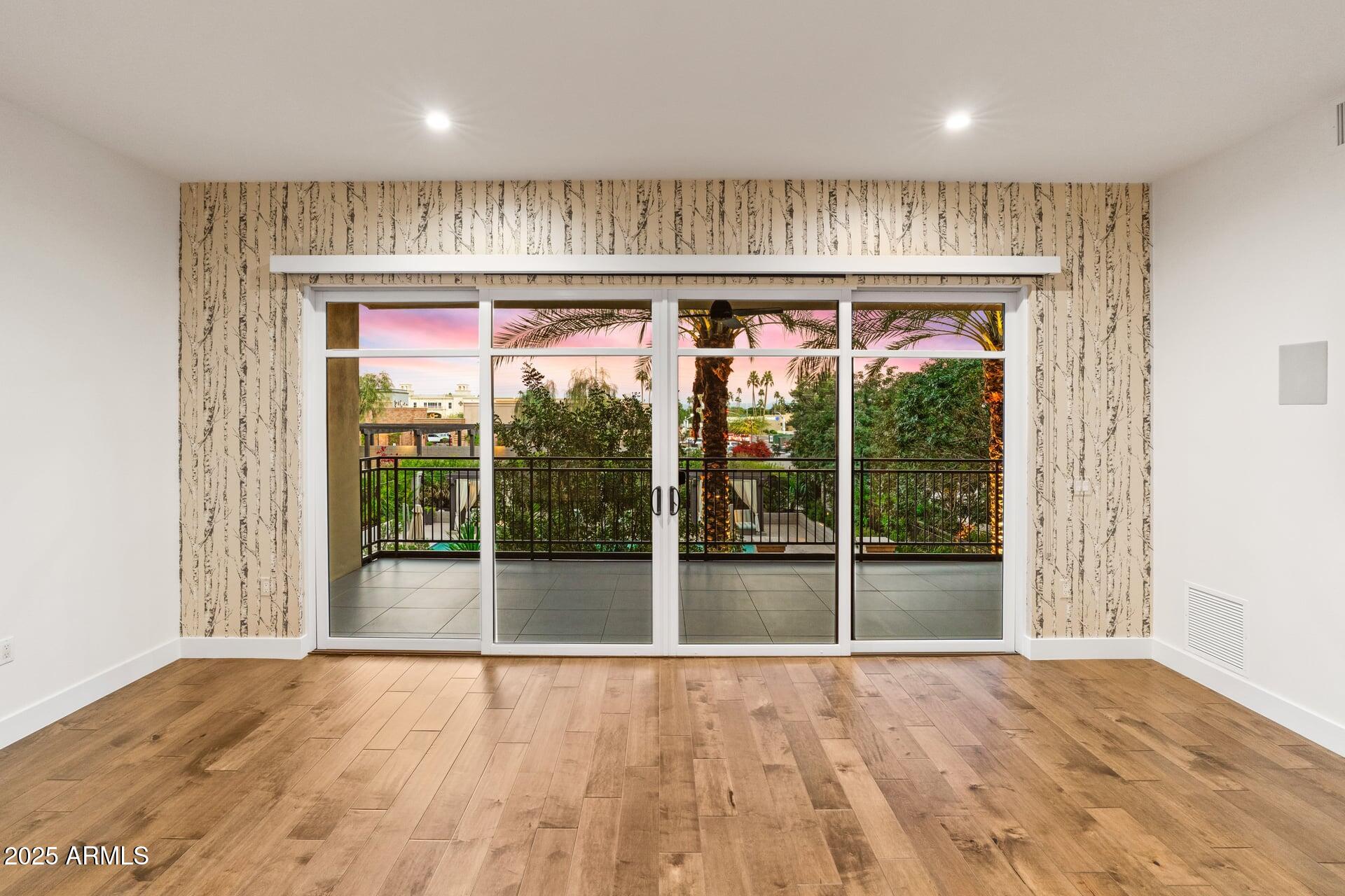 6166 North Scottsdale Road, Unit B2008 Paradise Valley, AZ 85253 - Photo 8 of 69 a view of an empty room with wooden floor and a window