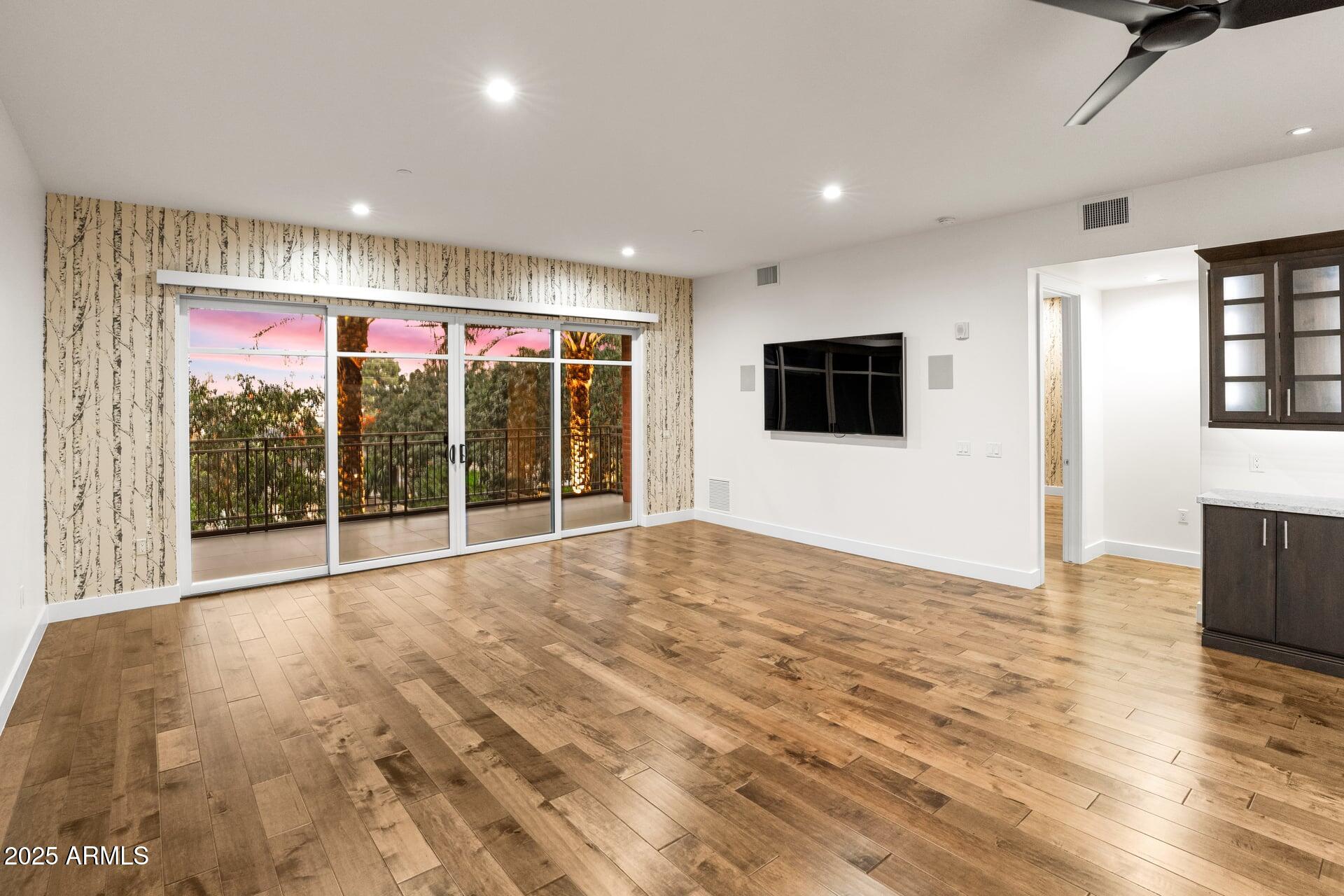 6166 North Scottsdale Road, Unit B2008 Paradise Valley, AZ 85253 - Photo 10 of 69 a view of an empty room with wooden floor and a window