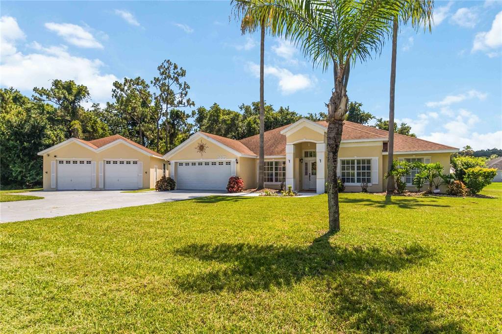 3225 Canoe Creek Road St. Cloud, FL 34772 - Photo 2 of 30 a front view of house with yard and swimming pool