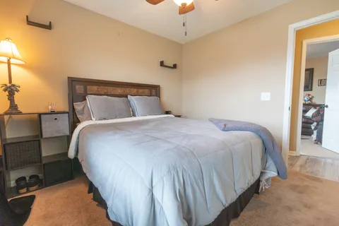 a bedroom with a bed and a night stand