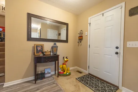 a view of a livingroom with wooden floor and a window