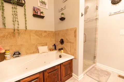 a bathroom with a tub sink and mirror