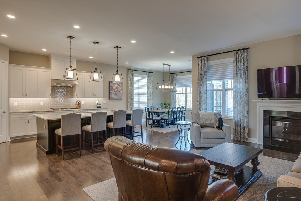 20 Sequoia Drive, Unit 20 Methuen, MA 01844 - Photo 11 of 42 a living room with furniture kitchen view and a fireplace