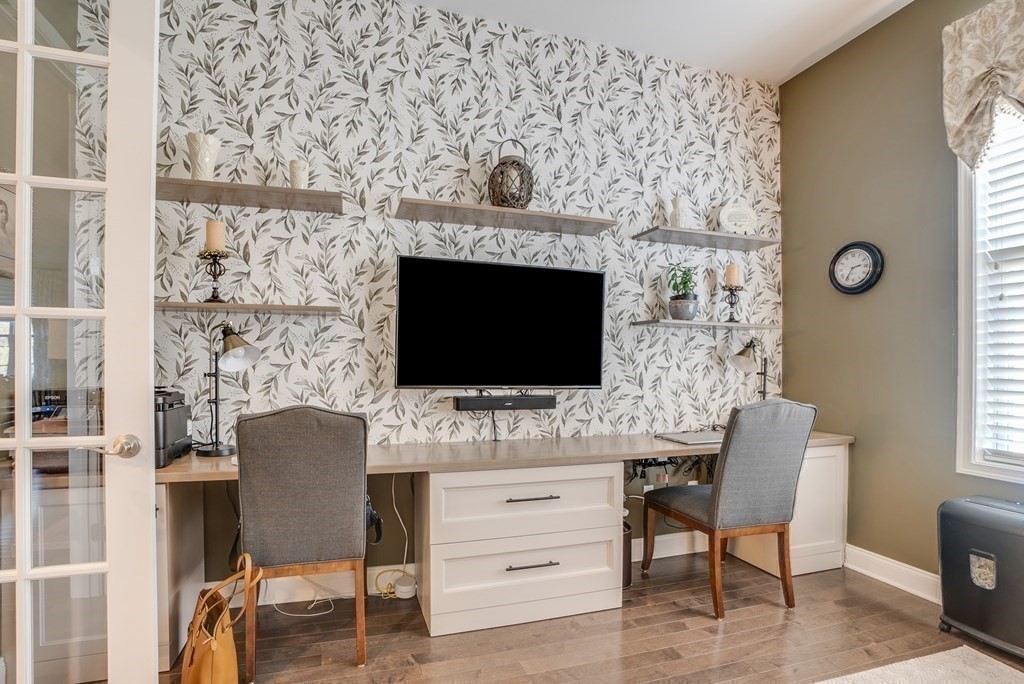 20 Sequoia Drive, Unit 20 Methuen, MA 01844 - Photo 19 of 42 a living room with a flat screen tv a table and a fireplace