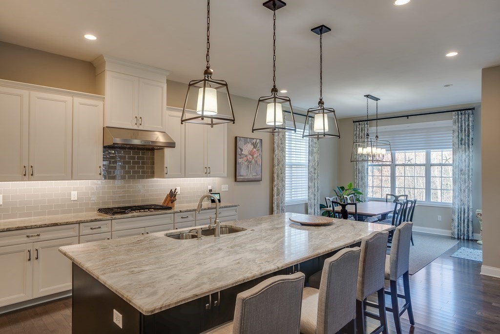 20 Sequoia Drive, Unit 20 Methuen, MA 01844 - Photo 8 of 42 a kitchen with granite countertop a sink a center island and cabinets