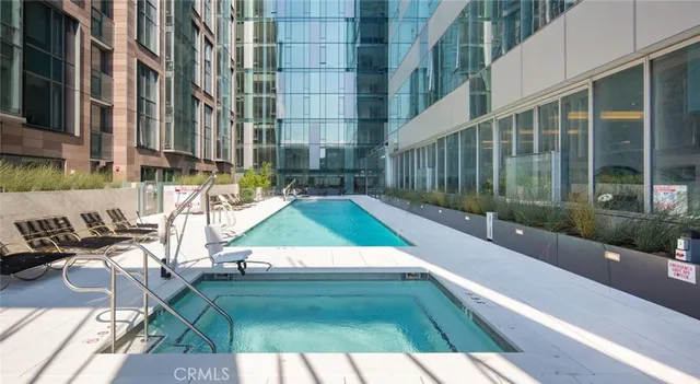 a living room with furniture and a book shelf