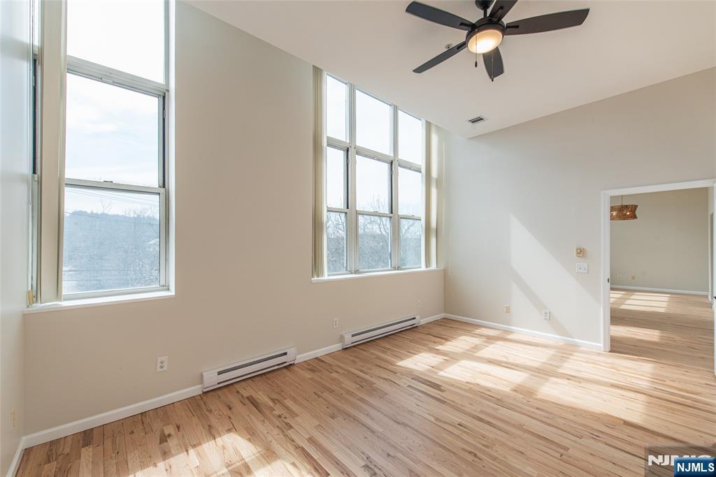 280 Main Street, Unit 305 Little Falls, NJ 07424 - Photo 12 of 24 a view of empty room with wooden floor and fan