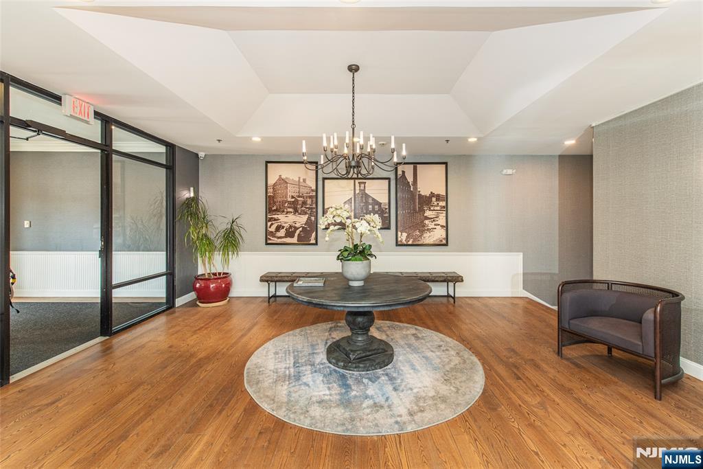 280 Main Street, Unit 305 Little Falls, NJ 07424 - Photo 17 of 24 a living room with couch and a chandelier