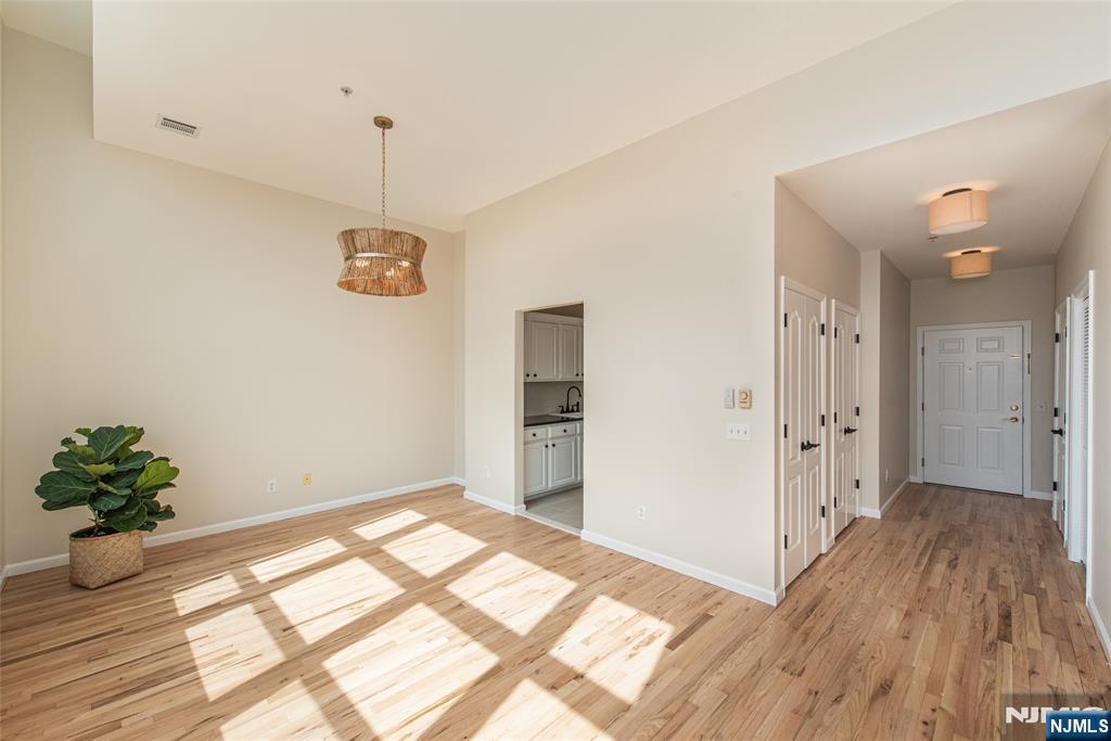 280 Main Street, Unit 305 Little Falls, NJ 07424 - Photo 3 of 24 a view of a room with wooden floor and bathroom