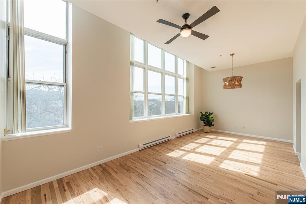 280 Main Street, Unit 305 Little Falls, NJ 07424 - Photo 4 of 24 a view of an empty room and window and wooden floor