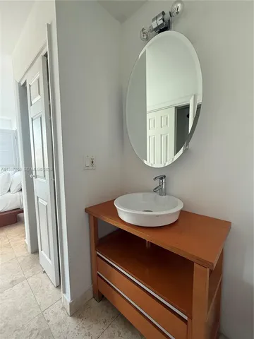 a white toilet sitting next to a shower