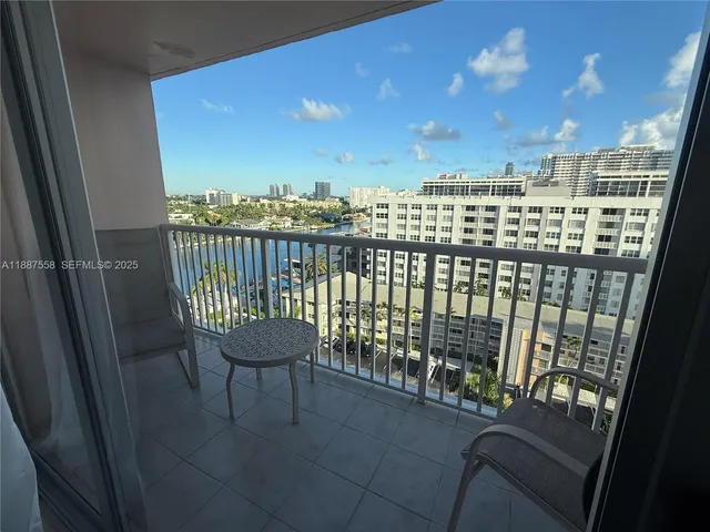 a view of a balcony with chair and city view
