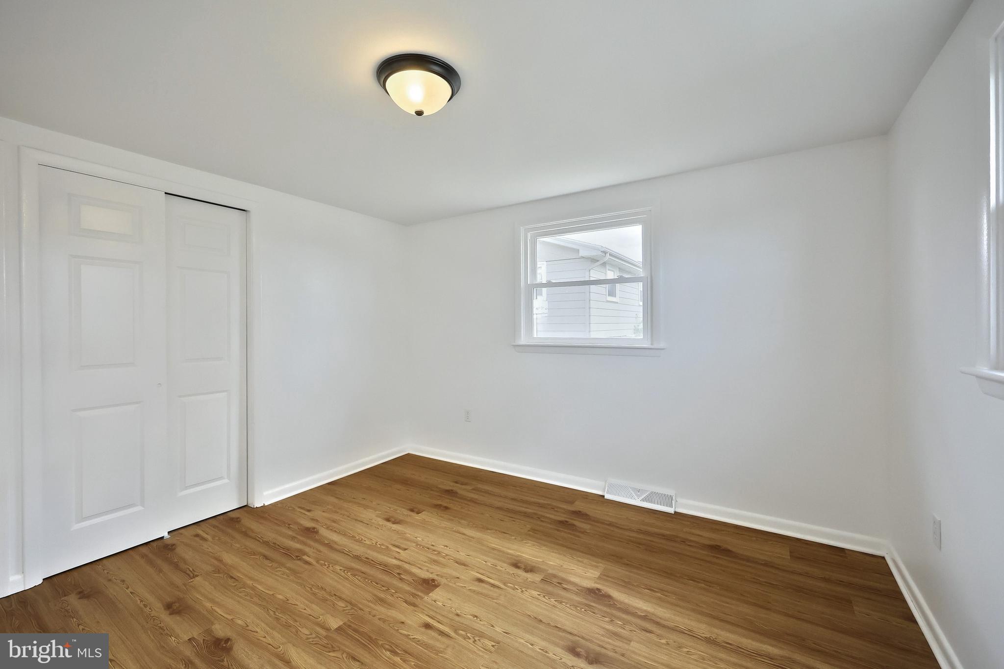 52 Oak Drive Hanover, PA 17331 - Photo 24 of 41 an empty room with wooden floor and windows