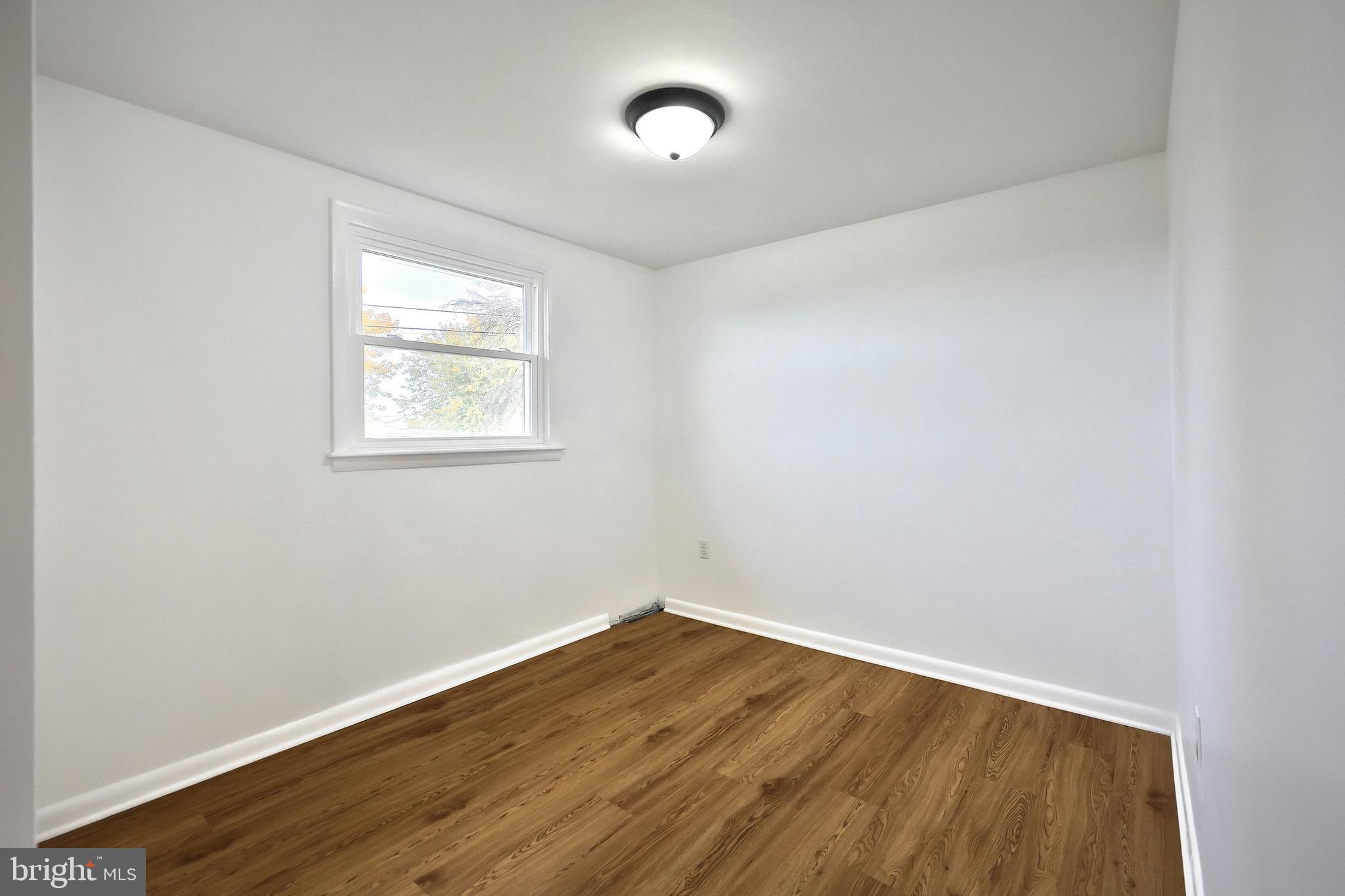 52 Oak Drive Hanover, PA 17331 - Photo 27 of 41 an empty room with wooden floor and a window