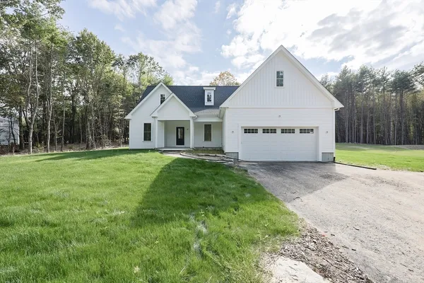 a front view of house with yard and green space