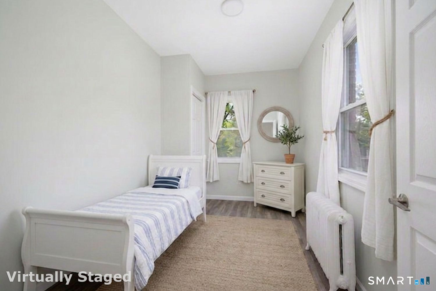 1040 Connecticut Avenue Bridgeport, CT 06607 - Photo 26 of 26 a bedroom with a bed a mirror and a window