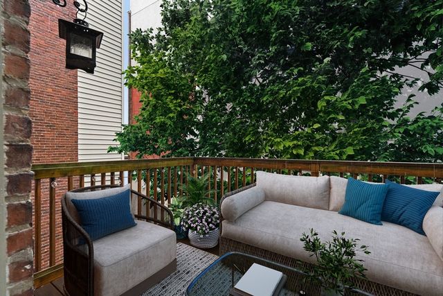 a balcony with wooden floor and furniture