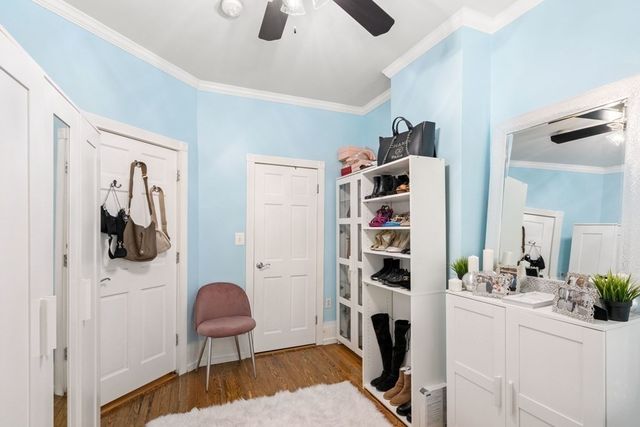 a view of walk in closet with clothes and shoes