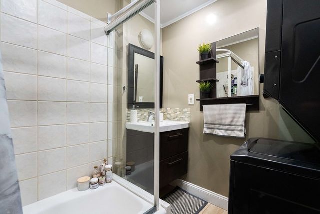 a bathroom with a sink vanity and a mirror