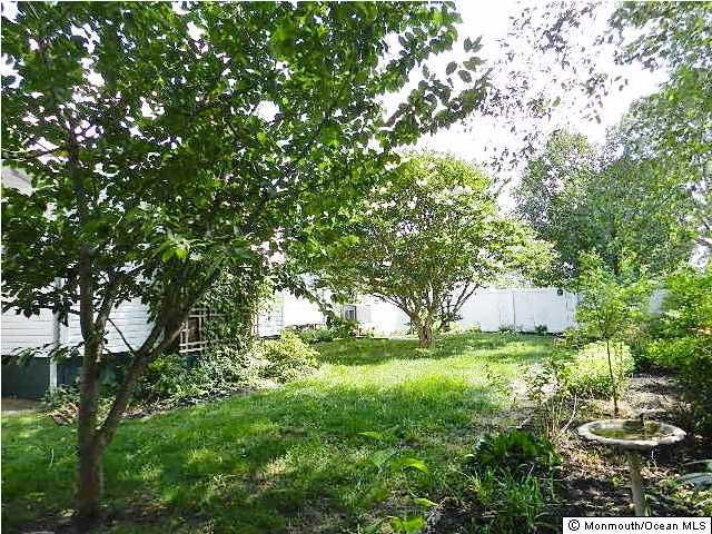 112 Jordan Road Brick, NJ 08724 - Photo 24 of 25 a backyard of a house with yard and outdoor seating