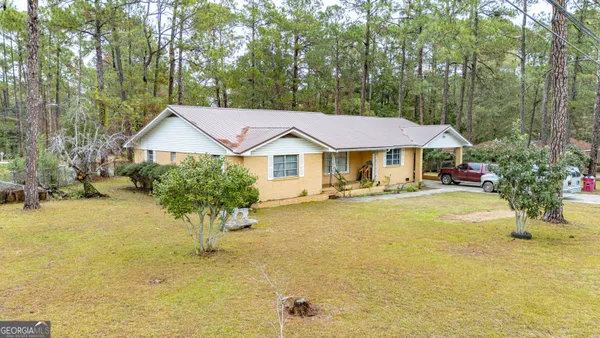 a front view of a house with yard and swimming pool