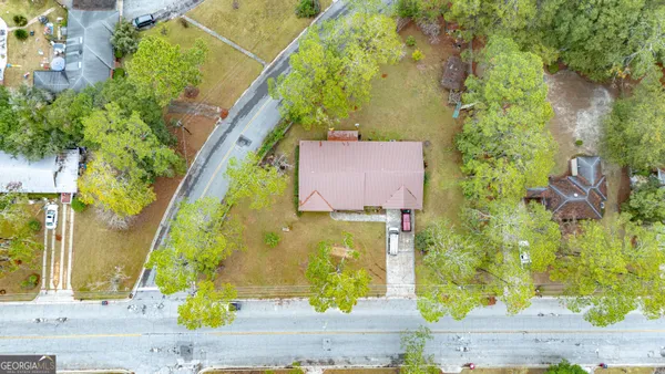 an aerial view of residential houses with yard