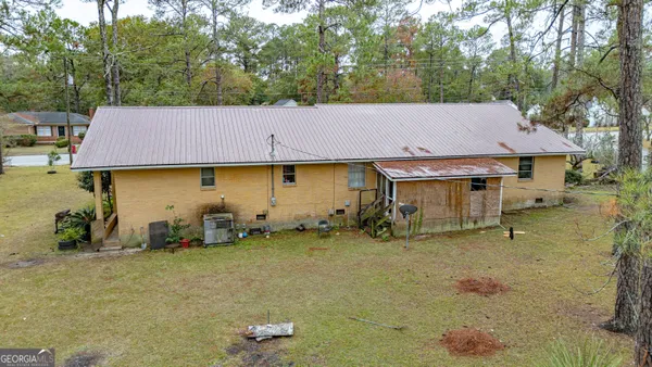 a small house with a sink and a chair