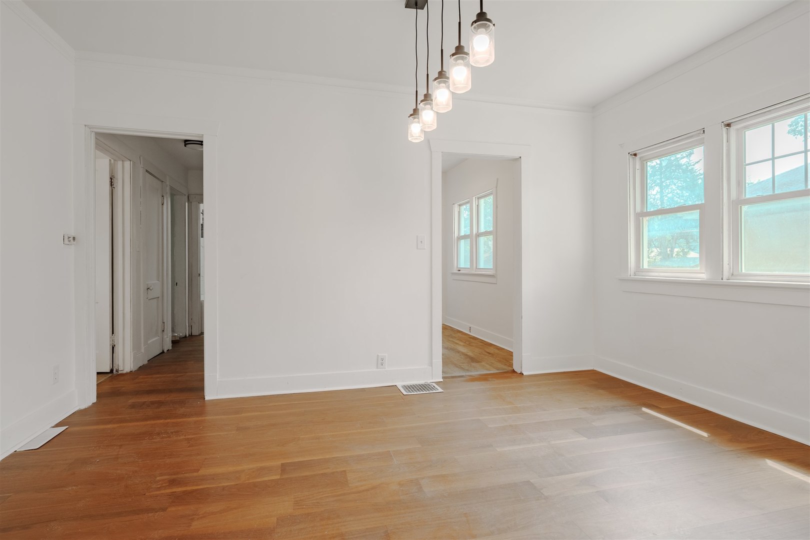 804 North Walnut Street Pontiac, IL 61764 - Photo 8 of 36 an empty room with wooden floor and windows