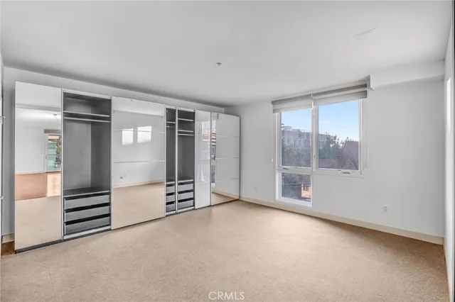 an empty room with entrance and windows