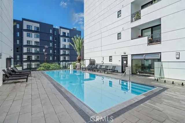 a view of a swimming pool with outdoor seating