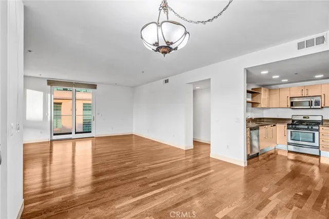 a view of a kitchen with a stove cabinets and wooden floor