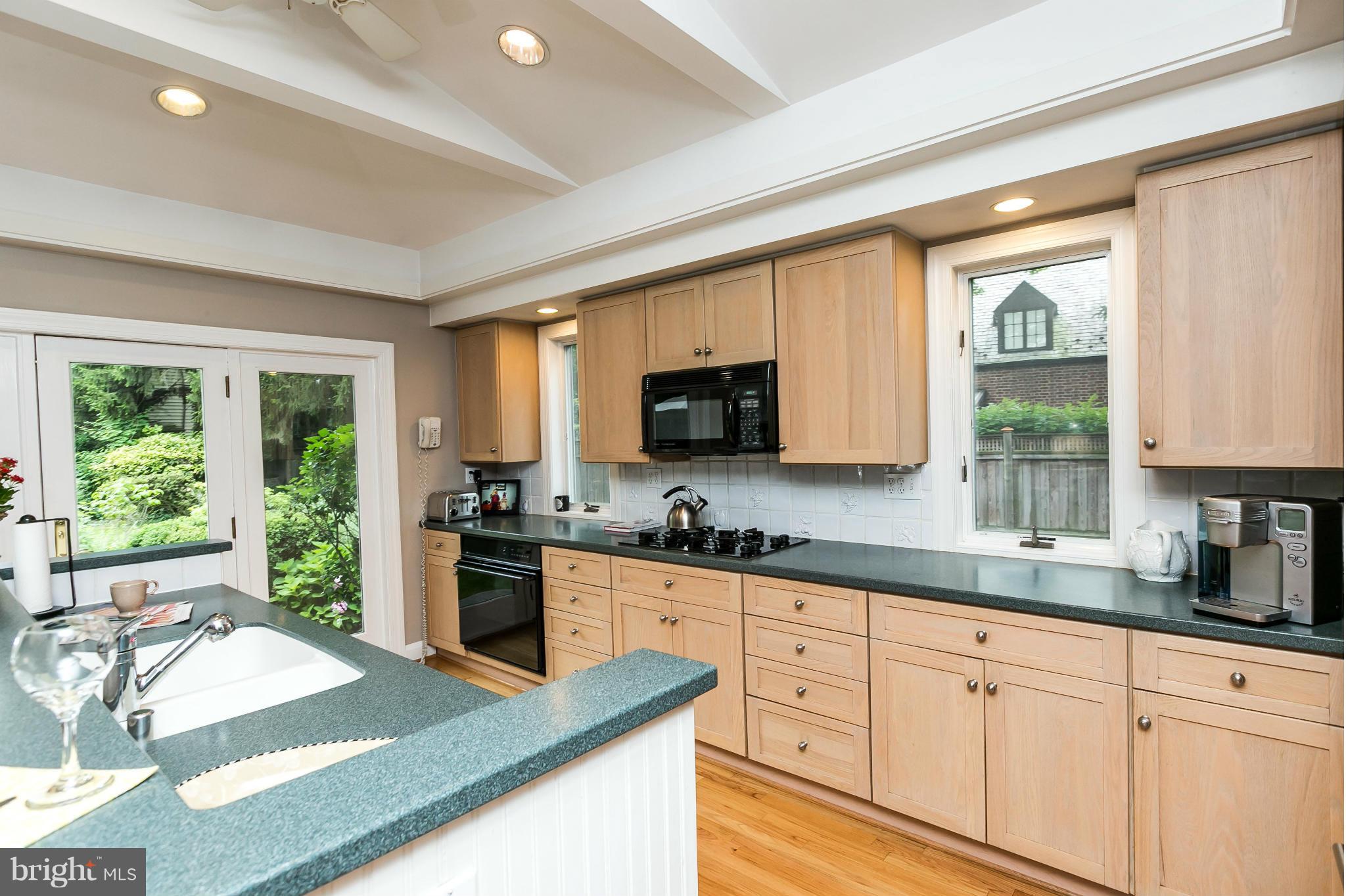 203 Midhurst Road Baltimore, MD 21212 - Photo 11 of 30 a kitchen with granite countertop a sink and white cabinets