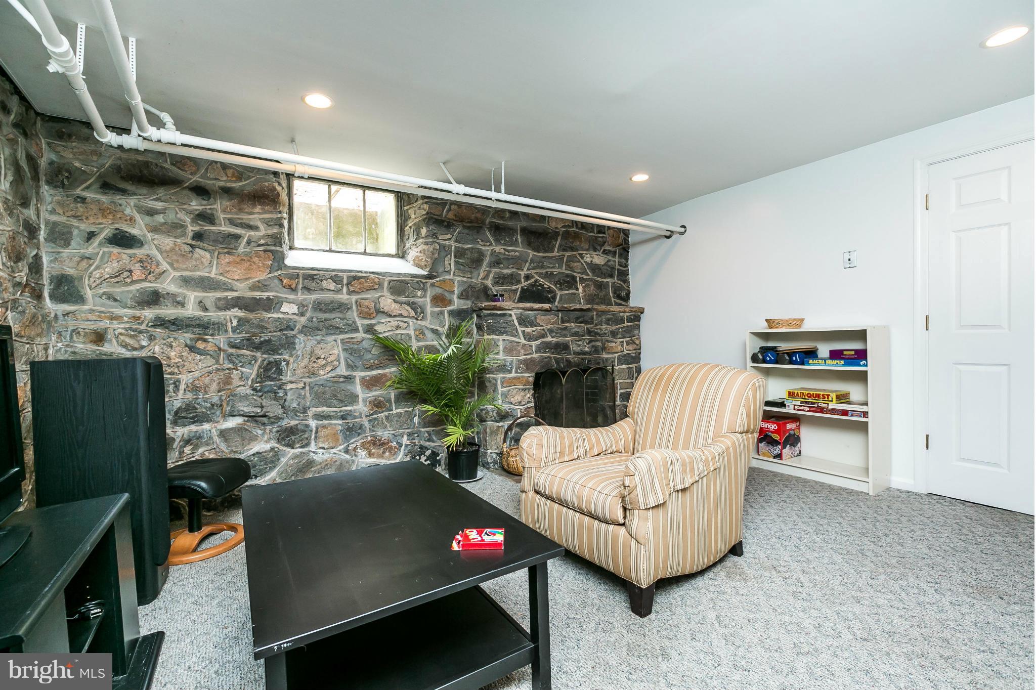203 Midhurst Road Baltimore, MD 21212 - Photo 23 of 30 a living room with furniture and a flat screen tv