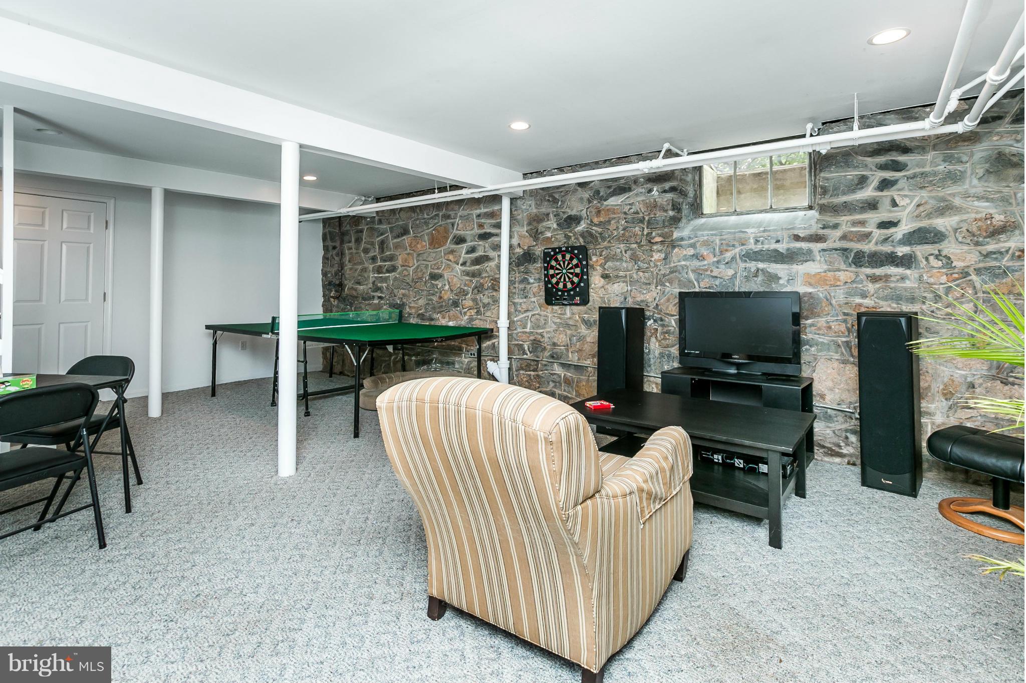 203 Midhurst Road Baltimore, MD 21212 - Photo 24 of 30 a living room with furniture a flat screen tv and a fireplace