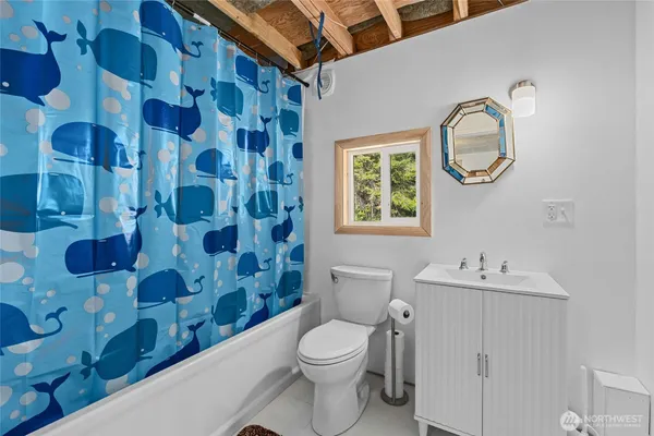 a bathroom with a sink a toilet and a mirror