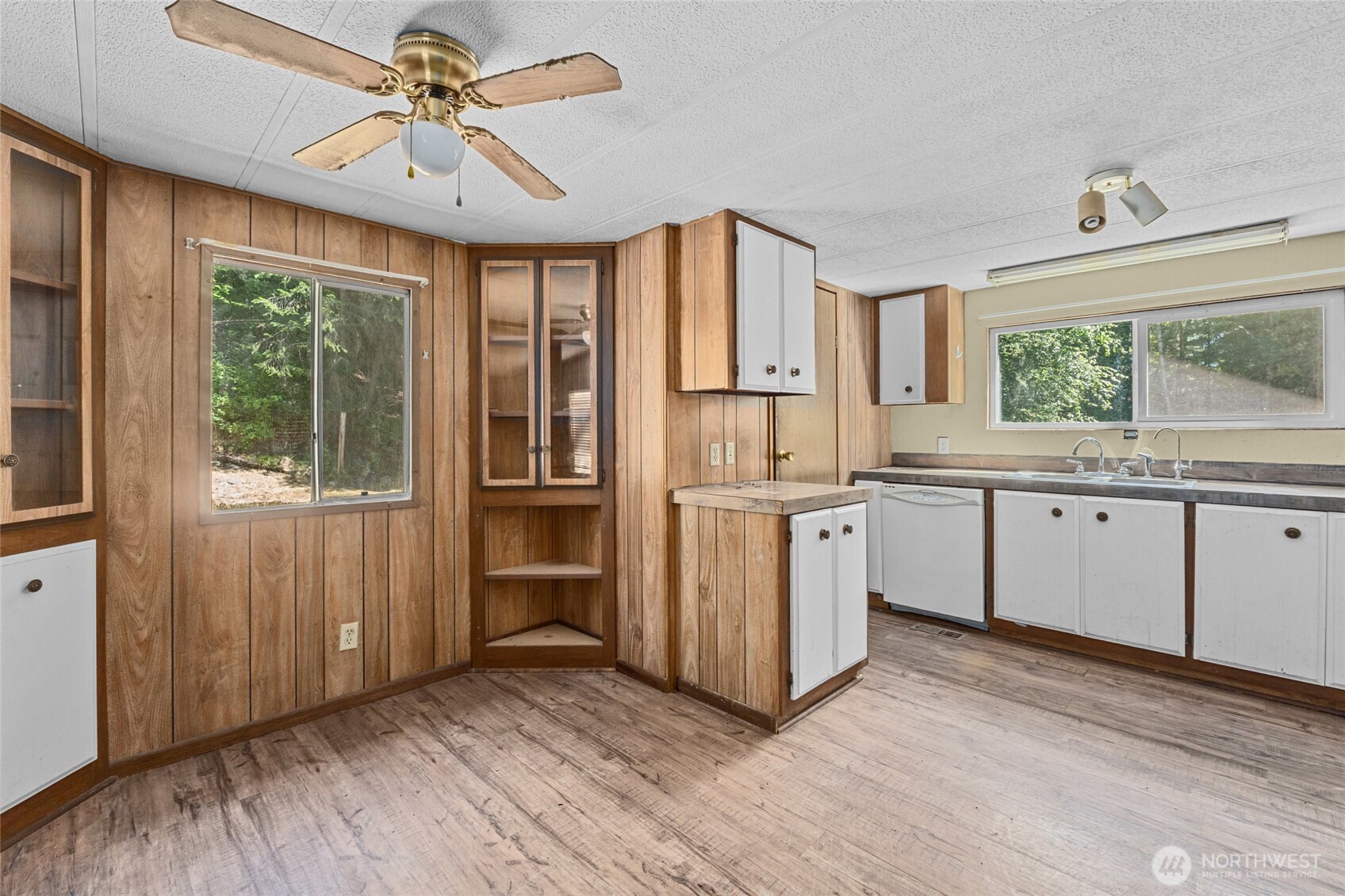28922 LeClerc Road North Ione, WA 99139 - Photo 19 of 31 a kitchen with white cabinets and wooden floors