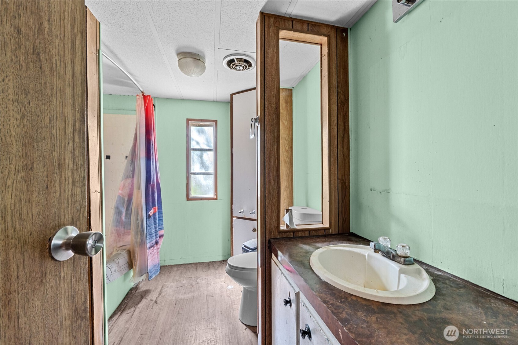 28922 LeClerc Road North Ione, WA 99139 - Photo 22 of 31 a bathroom with a granite countertop sink and a mirror