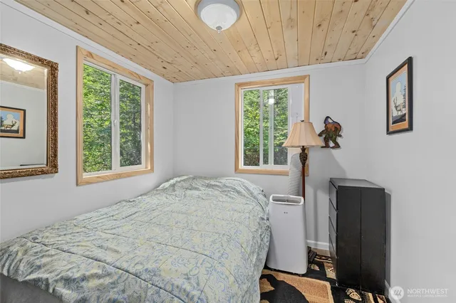a bed sitting in a bedroom next to a window