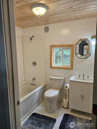 a bathroom with a toilet a sink and bathtub
