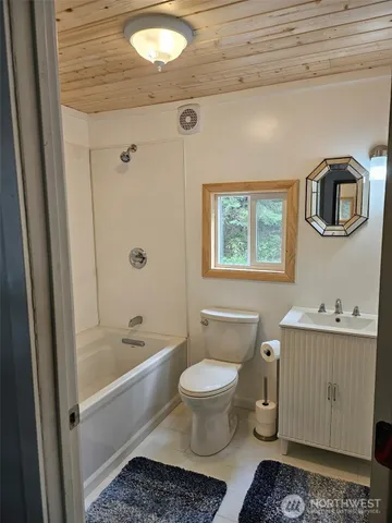 a bathroom with a toilet a sink and bathtub