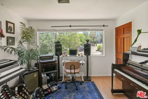 a view of a workspace with furniture and a window
