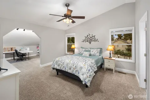 a spacious bedroom with a bed and a chandelier