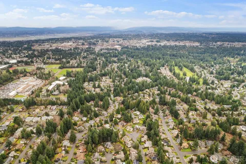 an aerial view of residential houses with city view and mountain view