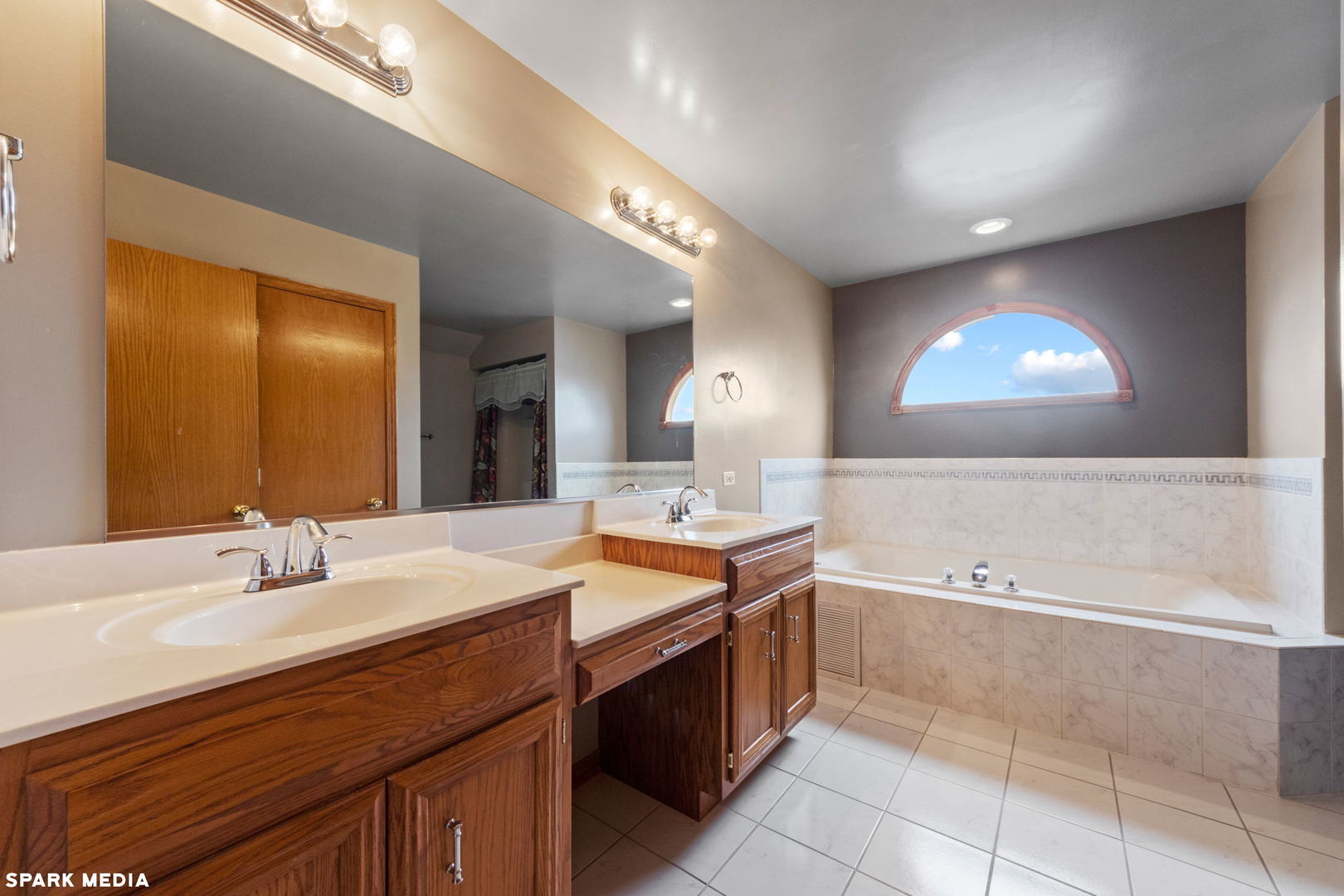 5642 Feather Creek Road Matteson, IL 60443 - Photo 18 of 36 a spacious bathroom with a double vanity sink a mirror and a bathtub