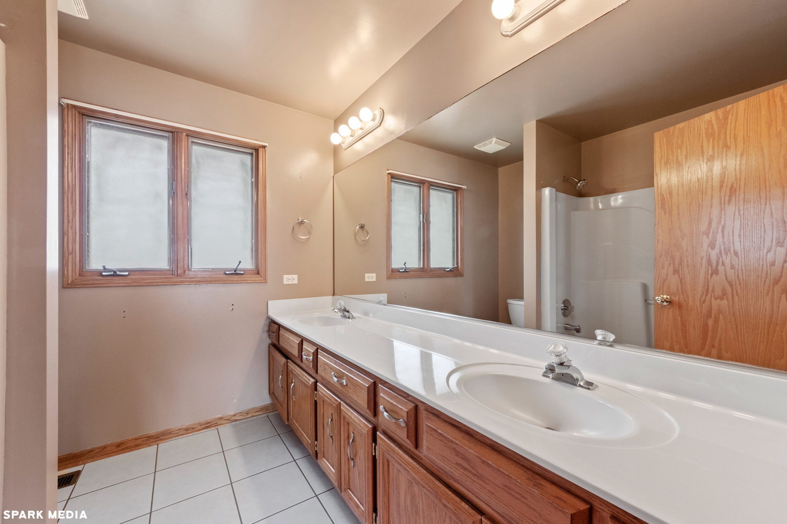 5642 Feather Creek Road Matteson, IL 60443 - Photo 22 of 36 a bathroom with a double vanity sink and a mirror